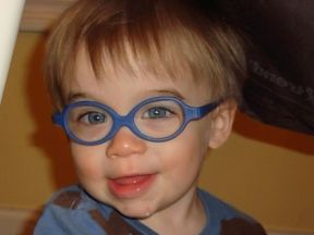 picture of a baby boy wearing glasses for farsightedness and pediatric cataracts