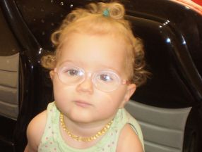 picture of a little girl wearing glasses