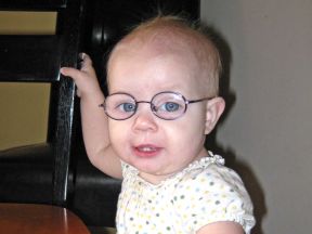 baby girl wearing glasses, 12 months old