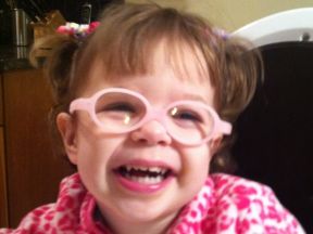 picture of a toddler girl wearing glasses for astigmatism