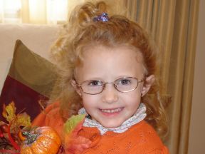 picture of a 4 year old girl in glasses.