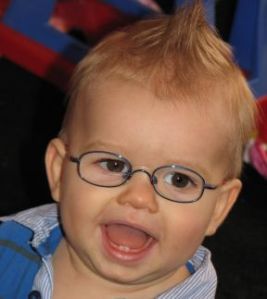 Lincoln, 12 months old. He has been wearing glasses since 10 months old for farsightedness and his frames are from OiO Eschenbach.