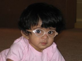 baby girl in glasses for farsightedness