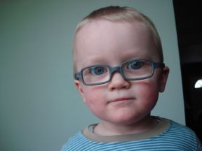 photo of a toddler boy wearing glasses