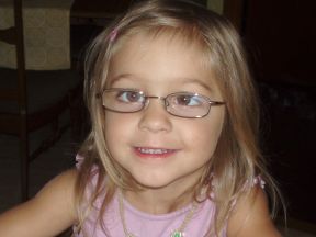 photo of a toddler girl wearing glasses for strabismus