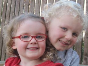 picture of young girl in glasses with older brother