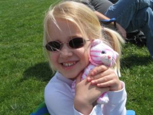 Emma in her glasses with transition lenses on a sunny day.